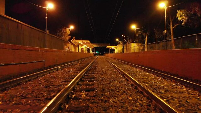 AERIAL Train Tracks at Night, Low to High Push In