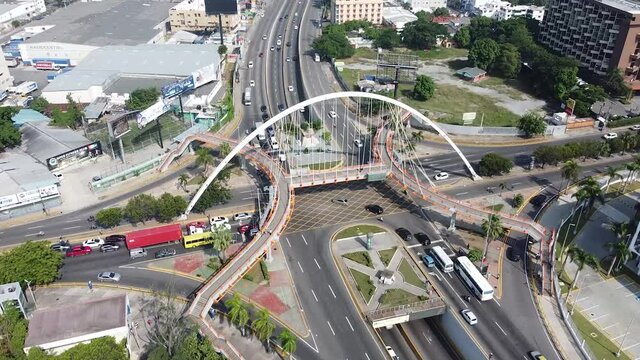 Top view of drone flying over the main street maximo gomez in the city of santo domingo, light traffic with cars waiting for traffic light.