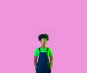 Young black woman isolated pink background looking aside curious and interested smiling happy on cropped advertising copyspace banner