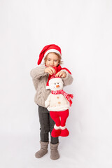 little girl in a Santa hat with a snowman on a white background, space for text