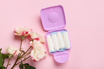 Tampons storage box and beautiful roses on pink background
