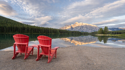 Peaceful sunrise lookout for two with mountain reflecting in lake´ s surface,Banff National Park, Canada