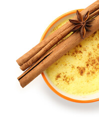 Cup of healthy turmeric latte with star anise and cinnamon on white background, closeup