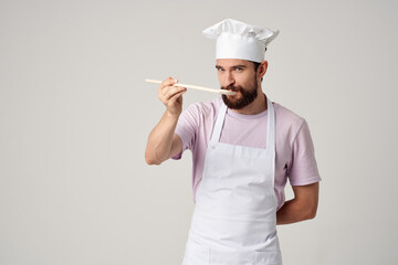 male chef with a cap on his head tasting food professional cooking