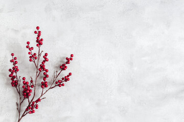 Christmas composition. Red berries on gray background. Christmas, winter, new year concept. Flat lay, top view
