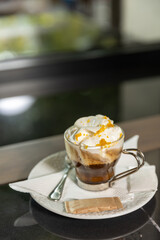Coffee with cream served on a wooden table in the restaurant