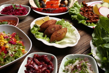 Salads with raw meatballs next to stuffed meatballs