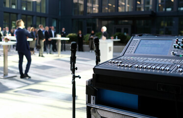 Outdoor business event - Microphone and audio equipment in the foreground