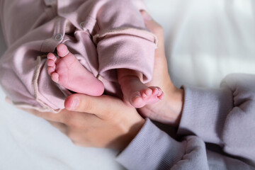 Newborn feets of caucasian newborn girl. Close-up.