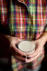 Fototapeta na wymiar Female hands with glasse of vegan milk, Alternative types of non-dairy milks, plant milk made of various grain, Clean eating, Healthy diet..
