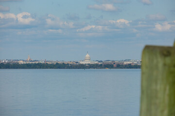 Impressive historic Capitol building with dome and columns in green tree park in Washington DC, D....