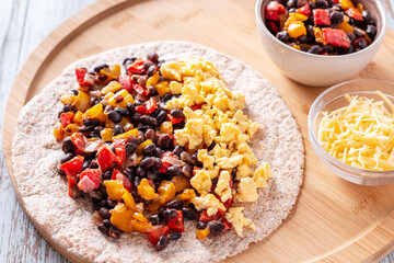 Beans and egg burritos with vegetables with whole-wheat tortillas