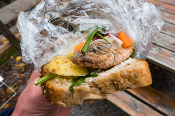 Stockholm, Sweden A herring sandwich with potatoes and dill on bread in a plastic wrap.