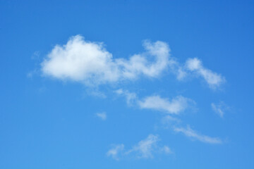 White clouds against clear blue sky for background or template