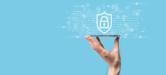 Fototapeta premium Protection network security computer and safe your data concept, Businessman holding shield protect icon. lock symbol, concept about security, cybersecurity and protection against dangers