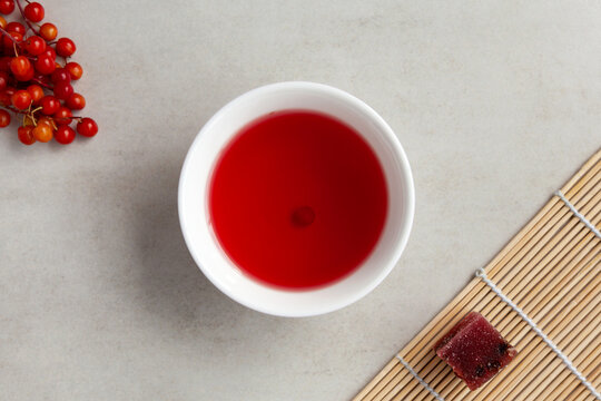 Omija tea (Omija cha) also known as schizandra tea in white bowl, top view. Brewed with schisandra berry