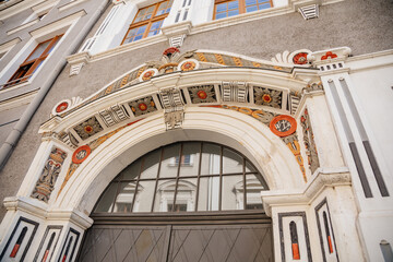 Goerlitz, Saxony, Germany, 04 September 2021: antique renaissance portal, floral ornaments, entrance to house at sunny summer day, historic building facade with stucco and statues, wood carved doors