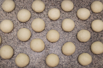 Dough. Bread dough. Fresh raw dough preparation. There are many round dough cookies on the table