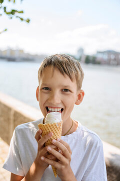 Happy boy with blond hair enjoying ice cream