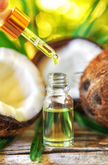 Natural coconut oil in a bottle. Selective focus.