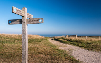 The South Downs Ways, Sussex, England. A signpost giving directions along the 100 mile walking route between Winchester and Eastbourne, South England. - 462154352