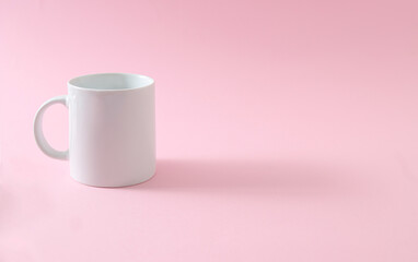 White empty mug in pink background with soft shadow. 