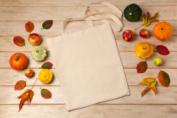 Rustic tote bag mockup with pumpkins and fall leaves