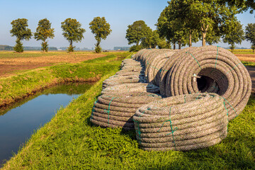 Rolls of new permeable pipes for the construction of a subsurface drainage system in a Dutch...
