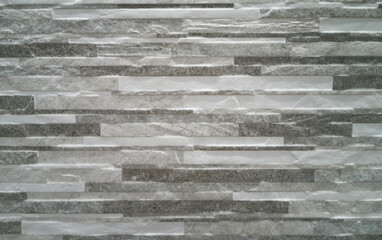 Artificial stone wall texture. Decorative stone. Artificial stone, brown and gray, interior design, furniture, abstracts and backgrounds. Thailand.