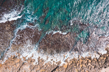 Aerial view of waves splashing on beach