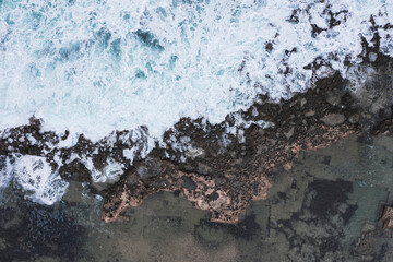 Aerial view of waves splashing on beach