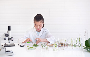 Child girl learning science and looking germs and bacteria in the laboratory. Early development and educational.