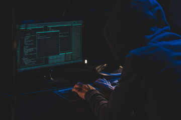 Cyber criminal hacking system at monitors, hacker hands at work. Internet crime concept. Hacker...