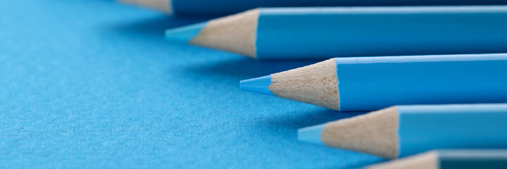 Many shades of blue wooden pencils background closeup