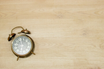 Vintage clock on wooden background