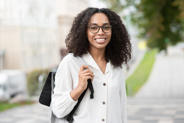 Young beautiful woman portrait, African student girl in a city, Young businesswoman smiling...