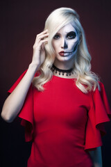 Beautiful girl in painted skull mask. Halloween Art make-up