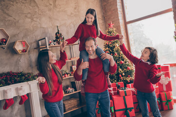 Photo of funny sweet mom dad sister brother smiling holding hands celebrating noel indoors house home room