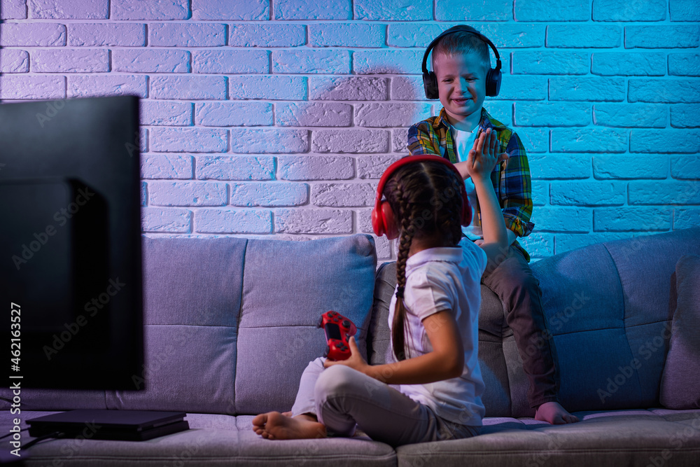 Poster children playing video game with game console