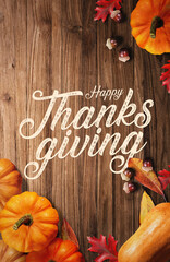 Happy Thanksgiving on Wooden Background with pumpkins and autumn leaves