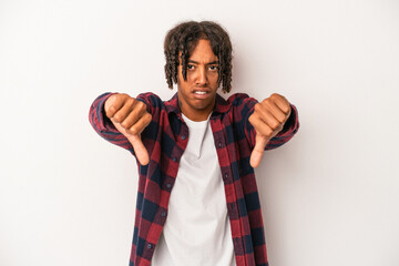 Young african american man isolated on white background showing thumb down and expressing dislike.