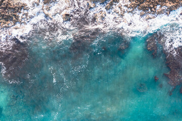 Aerial view of waves splashing on beach