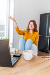 Defocus. Young woman is undergoing psychotherapy on the Internet using a computer. Girl looks into...