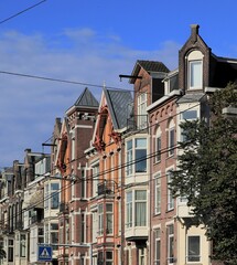 Fototapeta na wymiar Amsterdam Overtoom House Facades with Various Gables and Blue Sky, Netherlands.