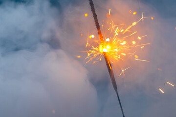 fire sparkler in dense smoke, abstract Christmas firework background