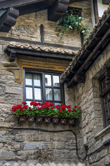 Fototapeta na wymiar Facade of a medieval building in the center of Pamplona, ​​medieval stone streets, typical and tourist alley of the city. Navarra Spain