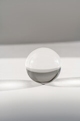 Transparent crystal ball on a white background.