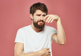 emotional man in a white t-shirt irritated facial expression Studio