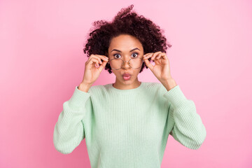 Portrait of impressed dark skin person hands touch eyeglasses look camera isolated on pink color background