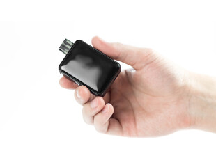 The hand holds an electronic cigarette. Close up